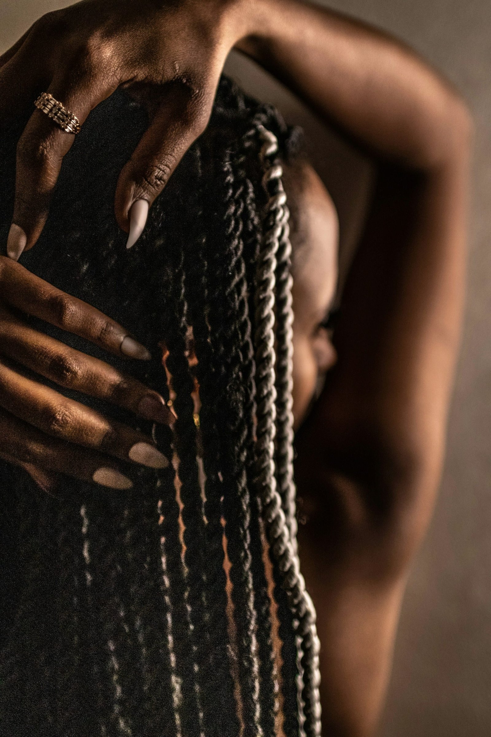 Close-up of a braider's hands weaving fine braids