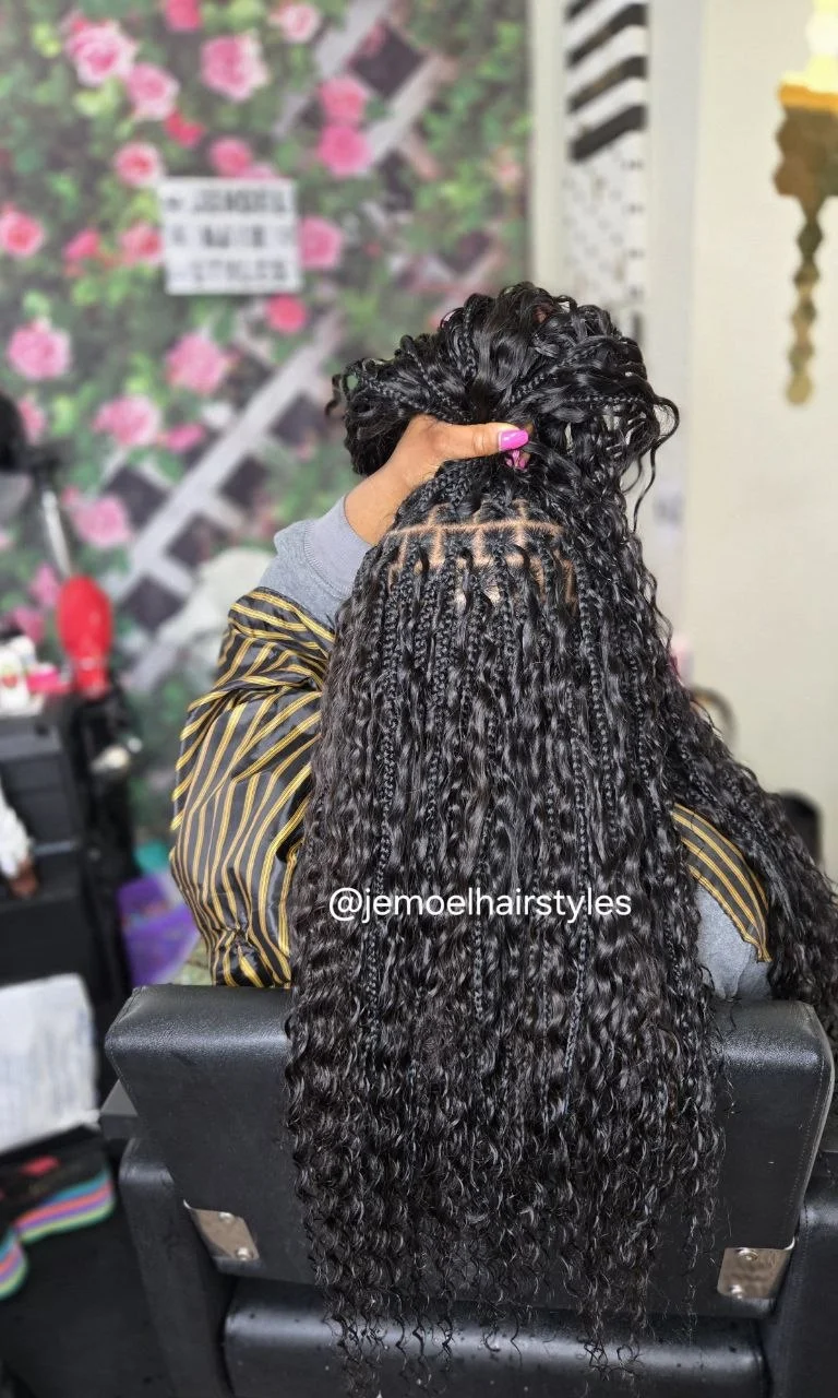 Back view of long boho braids with curly textured ends, styled and lifted up to show the parting.